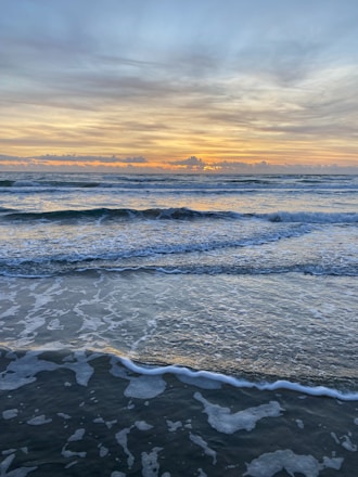 A peaceful beach scene with yoga mats laid out at sunrise.