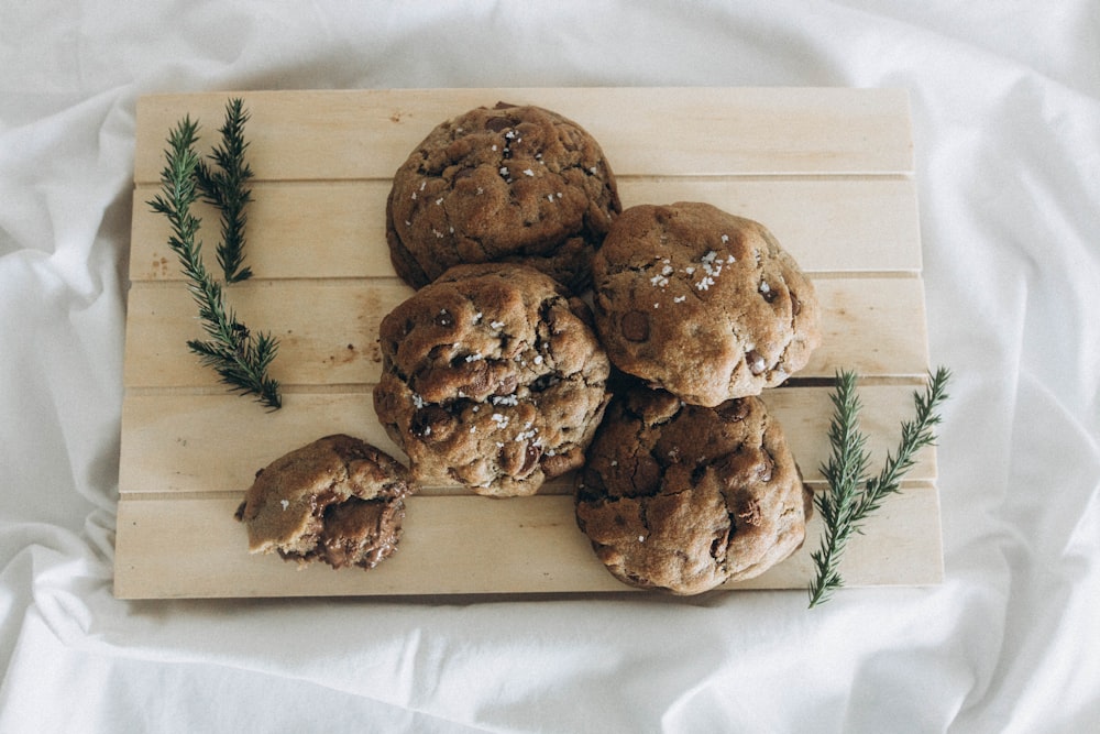 a wooden cutting board topped with chocolate chip cookies