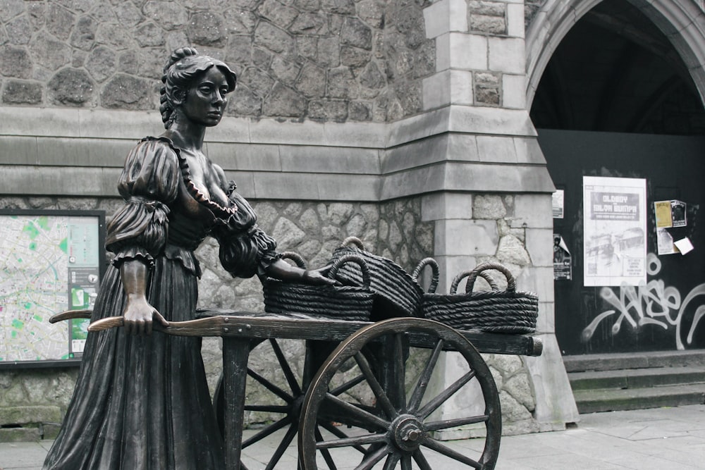 a statue of a woman pushing a baby carriage