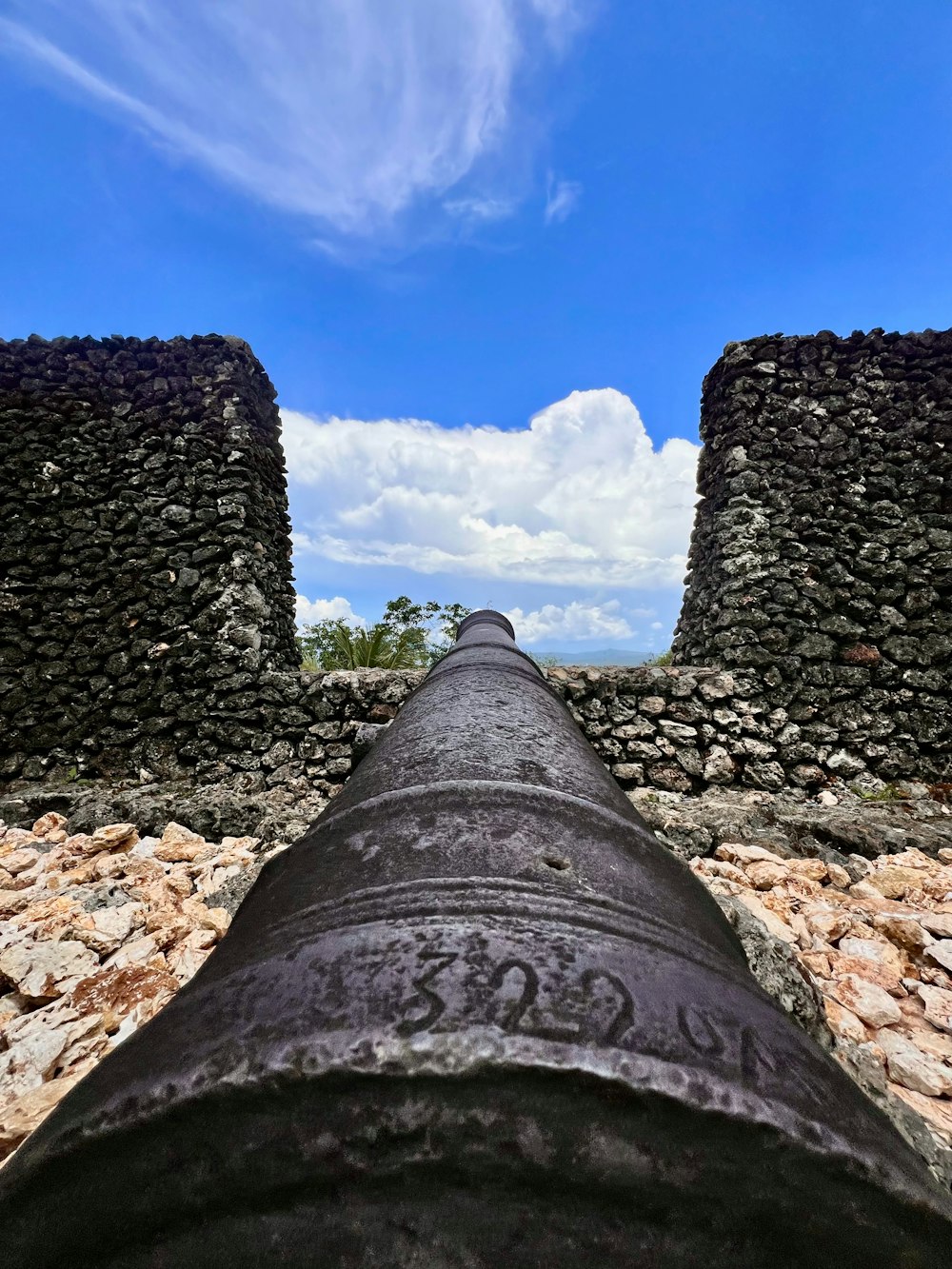 a large pipe sitting in the middle of a stone wall