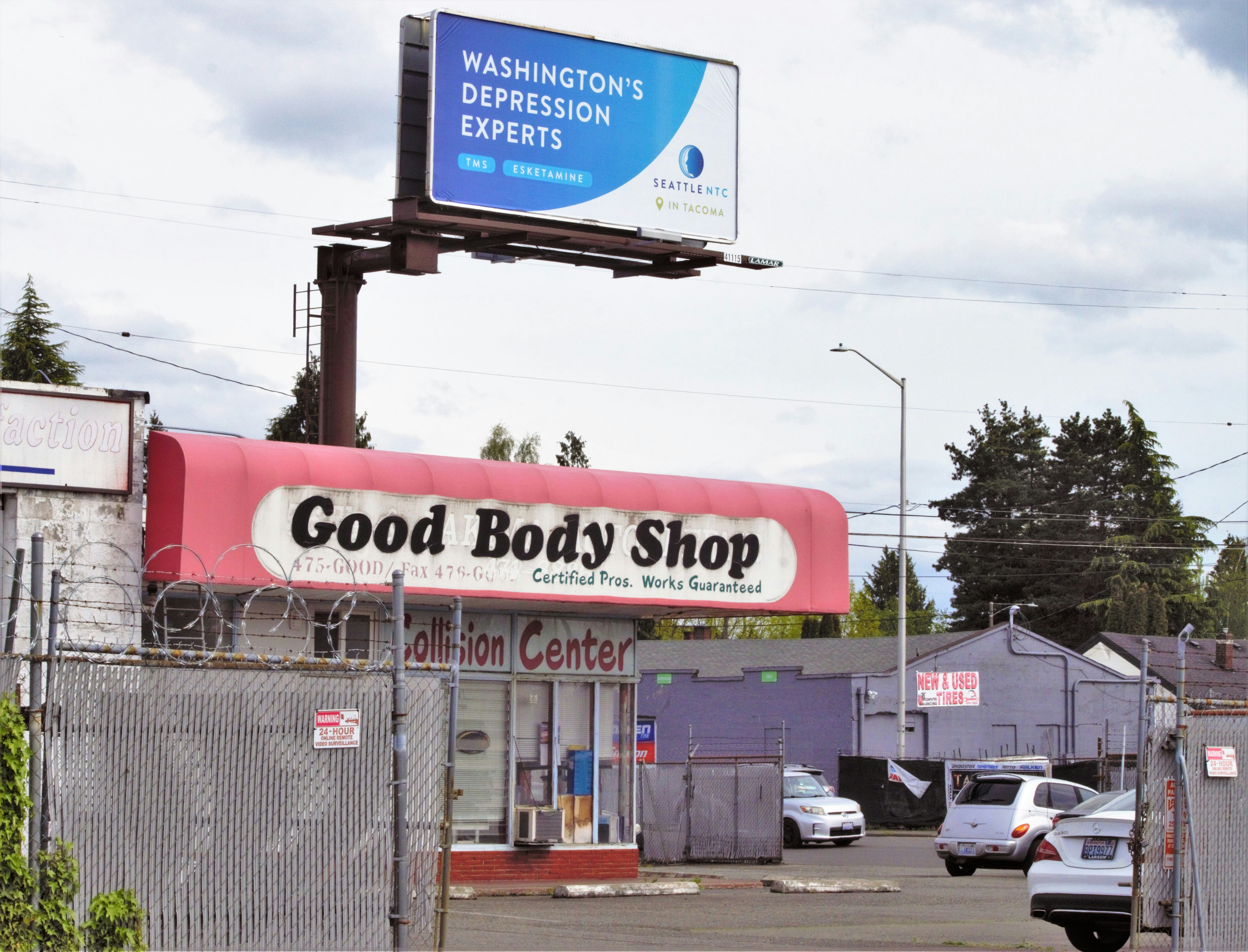 a billboard on the side of a building advertising a body shop