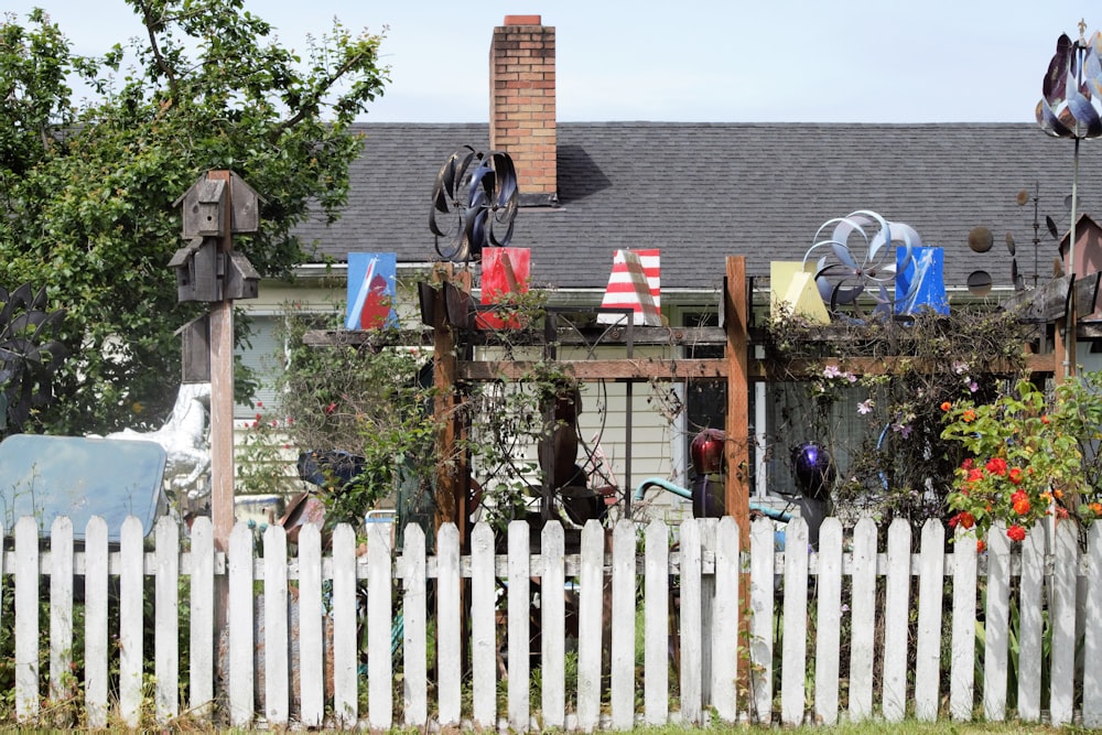 a white picket fence sitting in front of a house