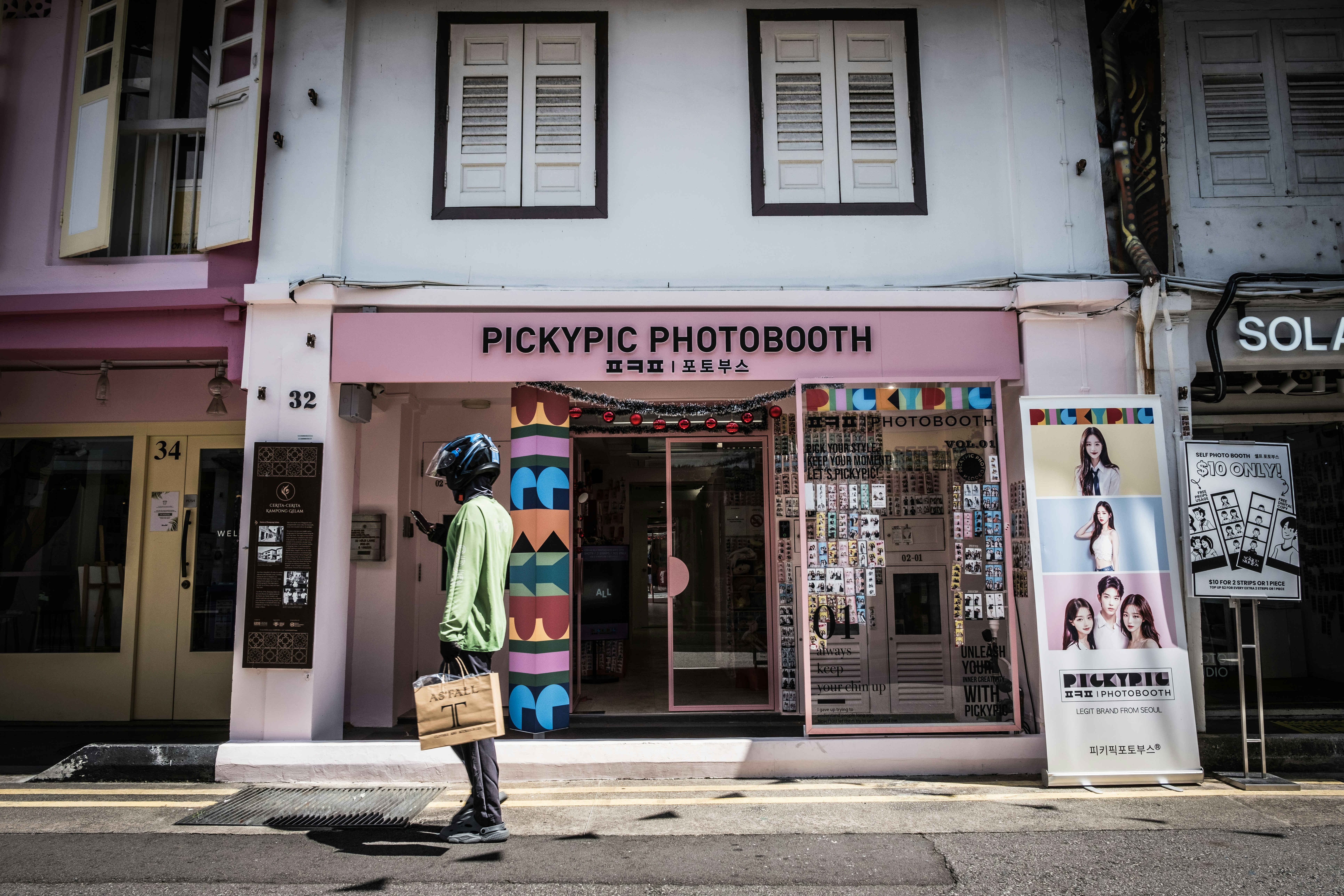 a person walking past a store front with a bag in front of it