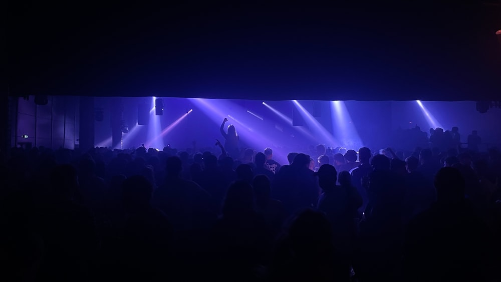 a group of people standing in front of a stage