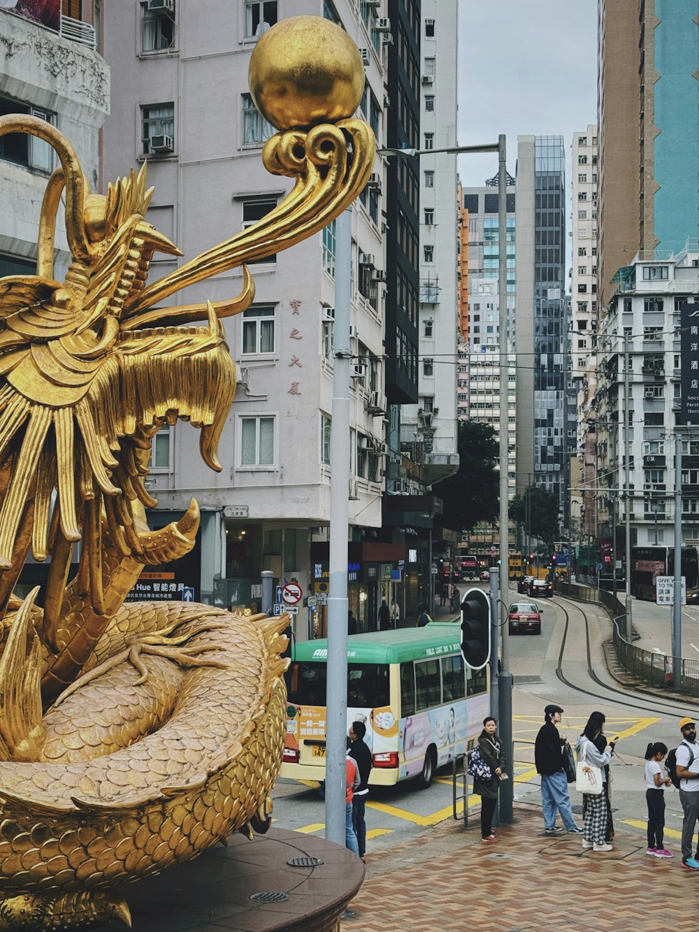 a statue of a dragon on a city street