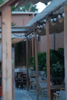 Outdoor patio featuring a wooden pergola and comfortable seating area.