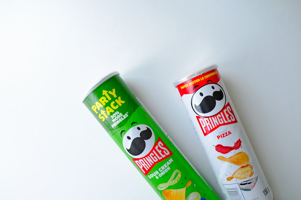 a tube of pringles next to a tube of chips