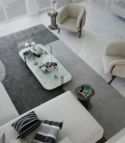 Elegant modern living room featuring a minimalist Swiss-inspired interior with a vintage Afghan rug as the centerpiece.