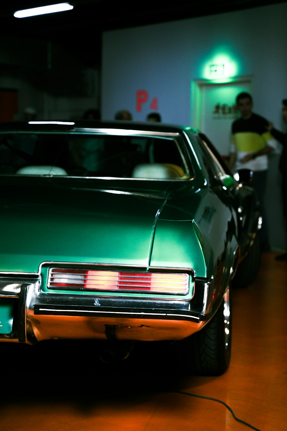 a green car parked inside of a garage