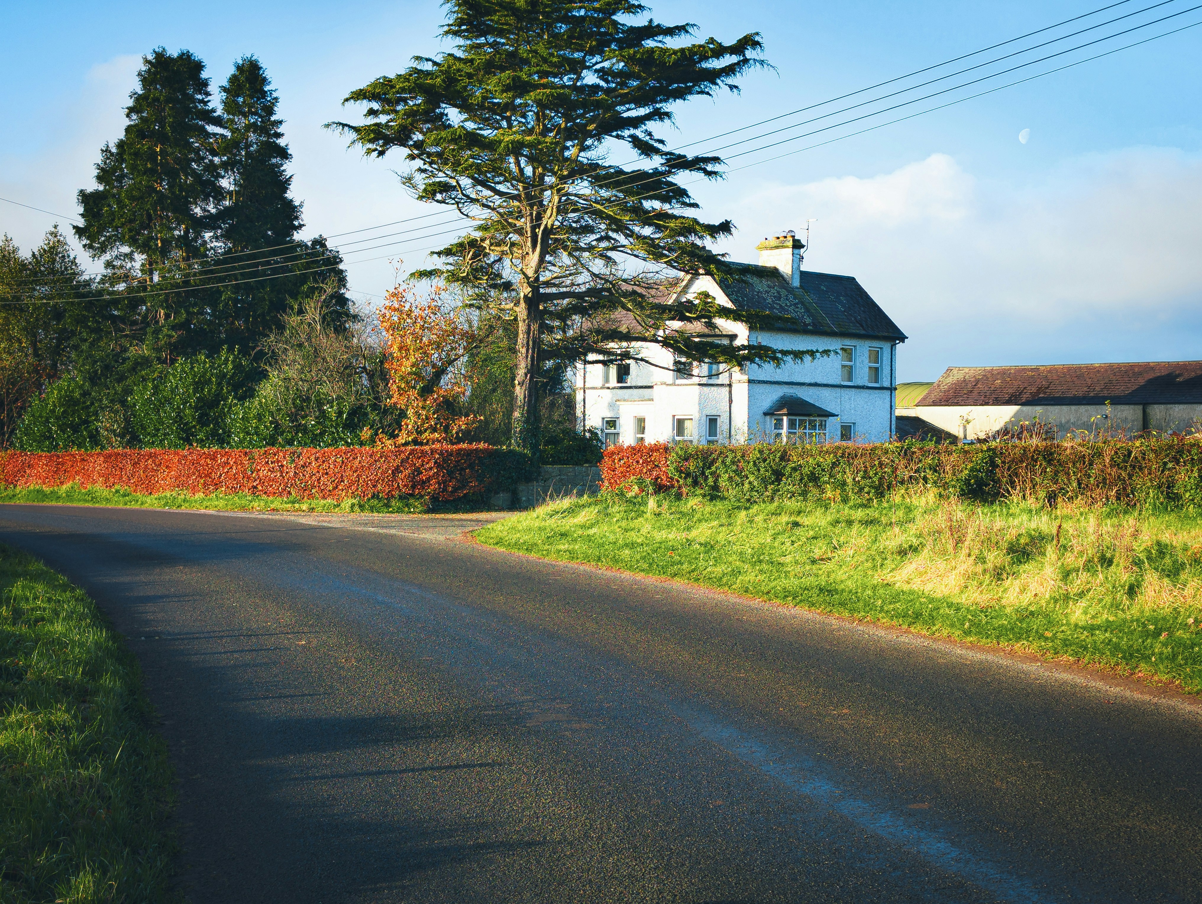 a white house sitting on the side of a road