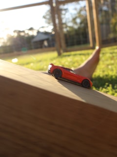 Papaw Stan and his grandson tuning their RC car together on a sunny afternoon.