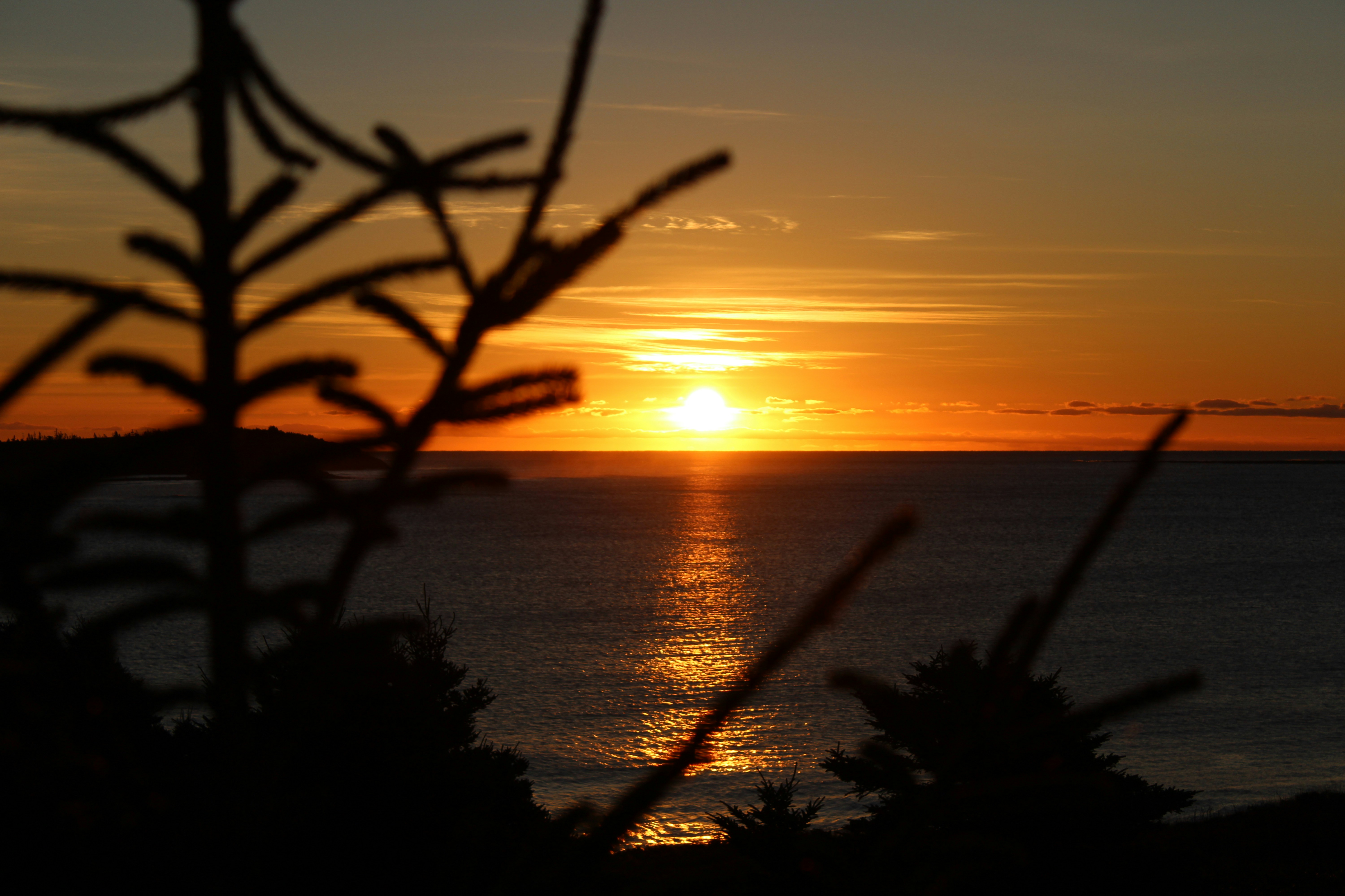 the sun is setting over a body of water, Sunrise on the Cliff