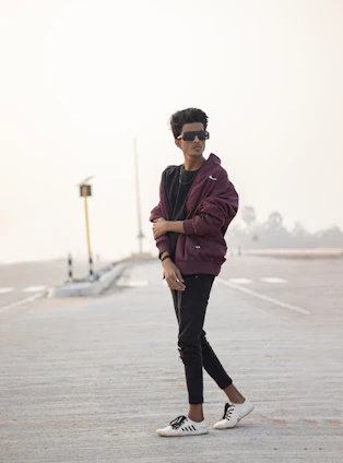 A stylish young person walking confidently through a bustling city street wearing Suzuki Apparel's latest collection.