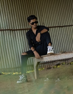 Casual Cannav outfit laid out on a wooden bench with accessories like sunglasses and watch.