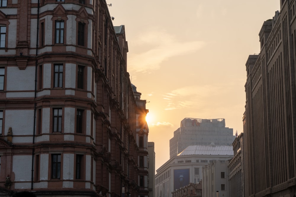 the sun is setting over a city street