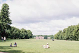 Green spaces in Millbrook with blooming flowers and people walking dogs on a sunny day.