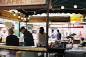 A group of travelers enjoying local cuisine at a bustling market.