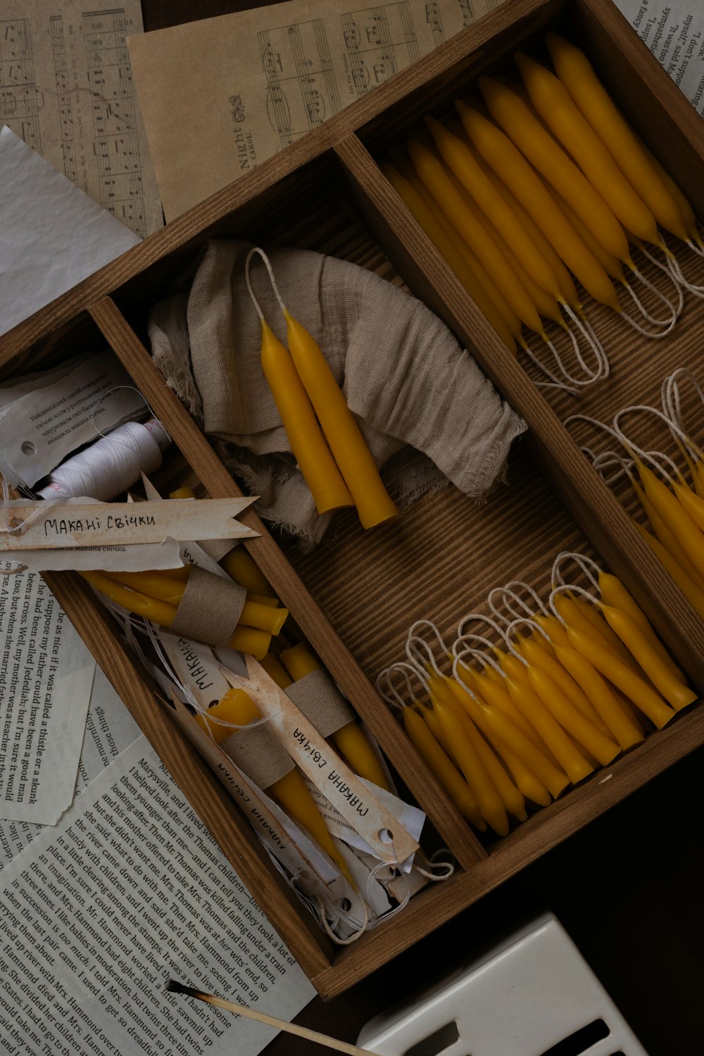a box filled with lots of yellow candles