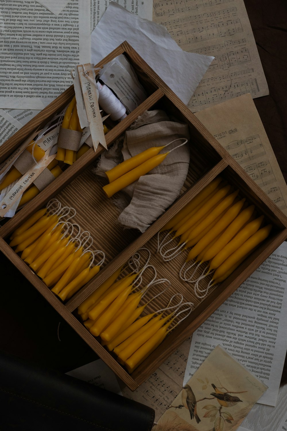 a box filled with yellow candles sitting on top of a table