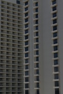 Two high-rise apartment buildings with multiple floors, featuring uniformly spaced windows and balconies.
