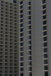 Two high-rise apartment buildings with multiple floors, featuring uniformly spaced windows and balconies.
