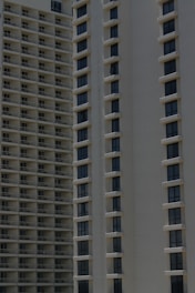 Two high-rise apartment buildings with multiple floors, featuring uniformly spaced windows and balconies.