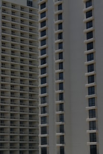 Two high-rise apartment buildings with multiple floors, featuring uniformly spaced windows and balconies.
