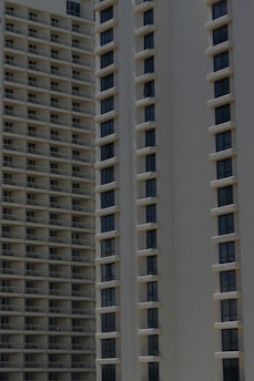 Two high-rise apartment buildings with multiple floors, featuring uniformly spaced windows and balconies.