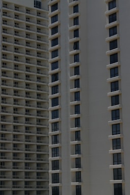 Two high-rise apartment buildings with multiple floors, featuring uniformly spaced windows and balconies.