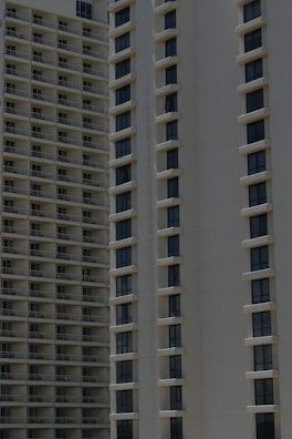 Two high-rise apartment buildings with multiple floors, featuring uniformly spaced windows and balconies.