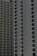 Two high-rise apartment buildings with multiple floors, featuring uniformly spaced windows and balconies.