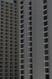 Two high-rise apartment buildings with multiple floors, featuring uniformly spaced windows and balconies.