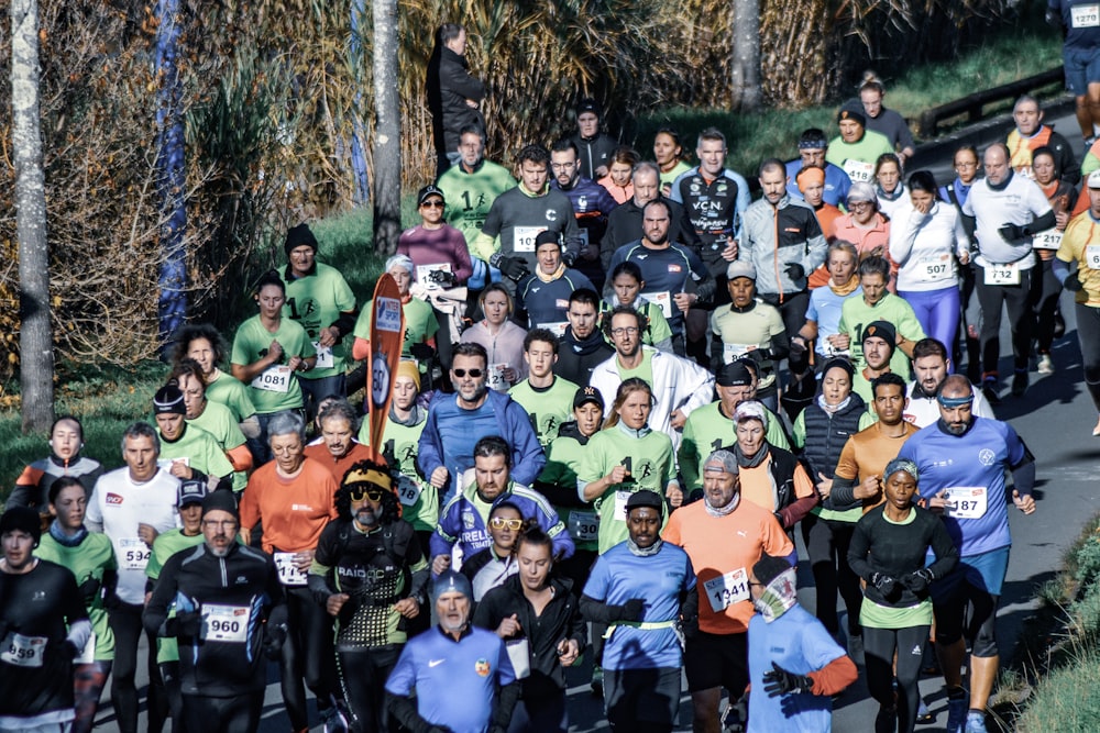 a large group of people running down a road