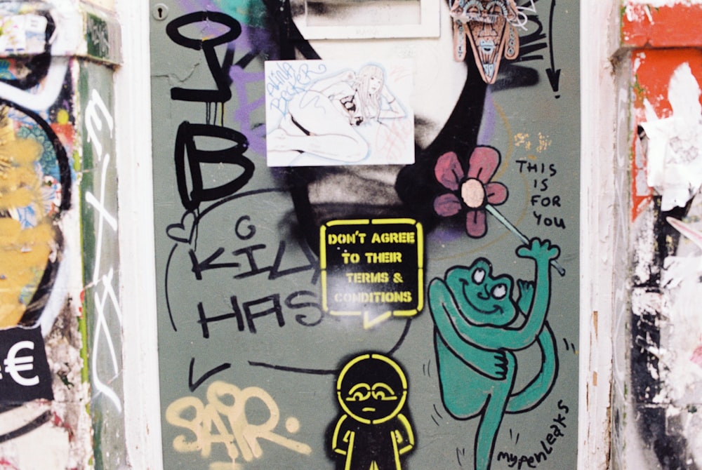 a door covered in graffiti and stickers