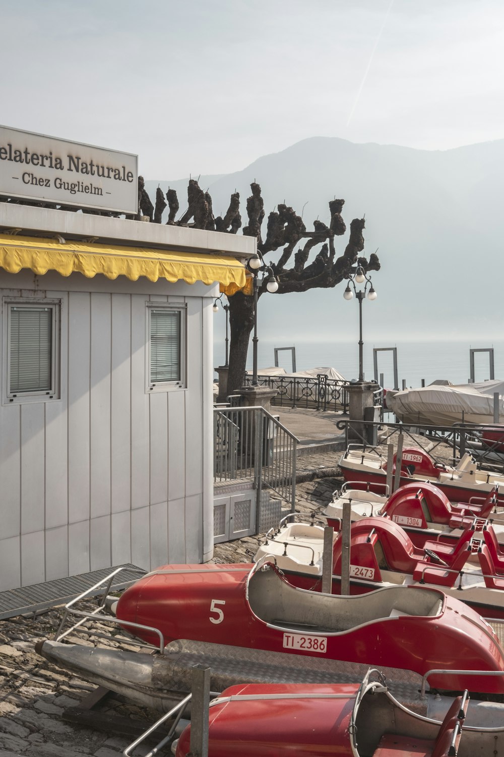 a row of red canoes sitting next to a white building