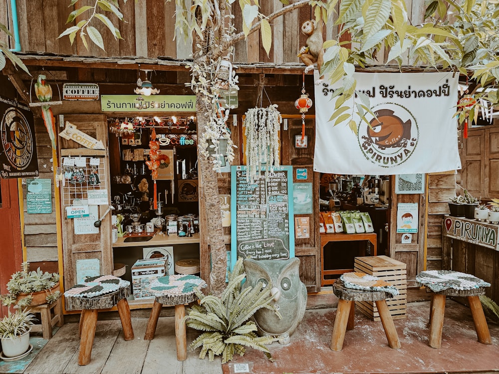 a store with a sign and a bunch of stools in front of it