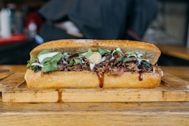 a sandwich is sitting on a cutting board