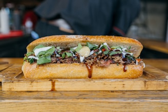 a sandwich is sitting on a cutting board