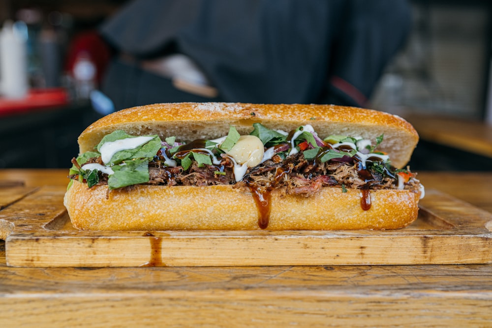 a sandwich is sitting on a cutting board