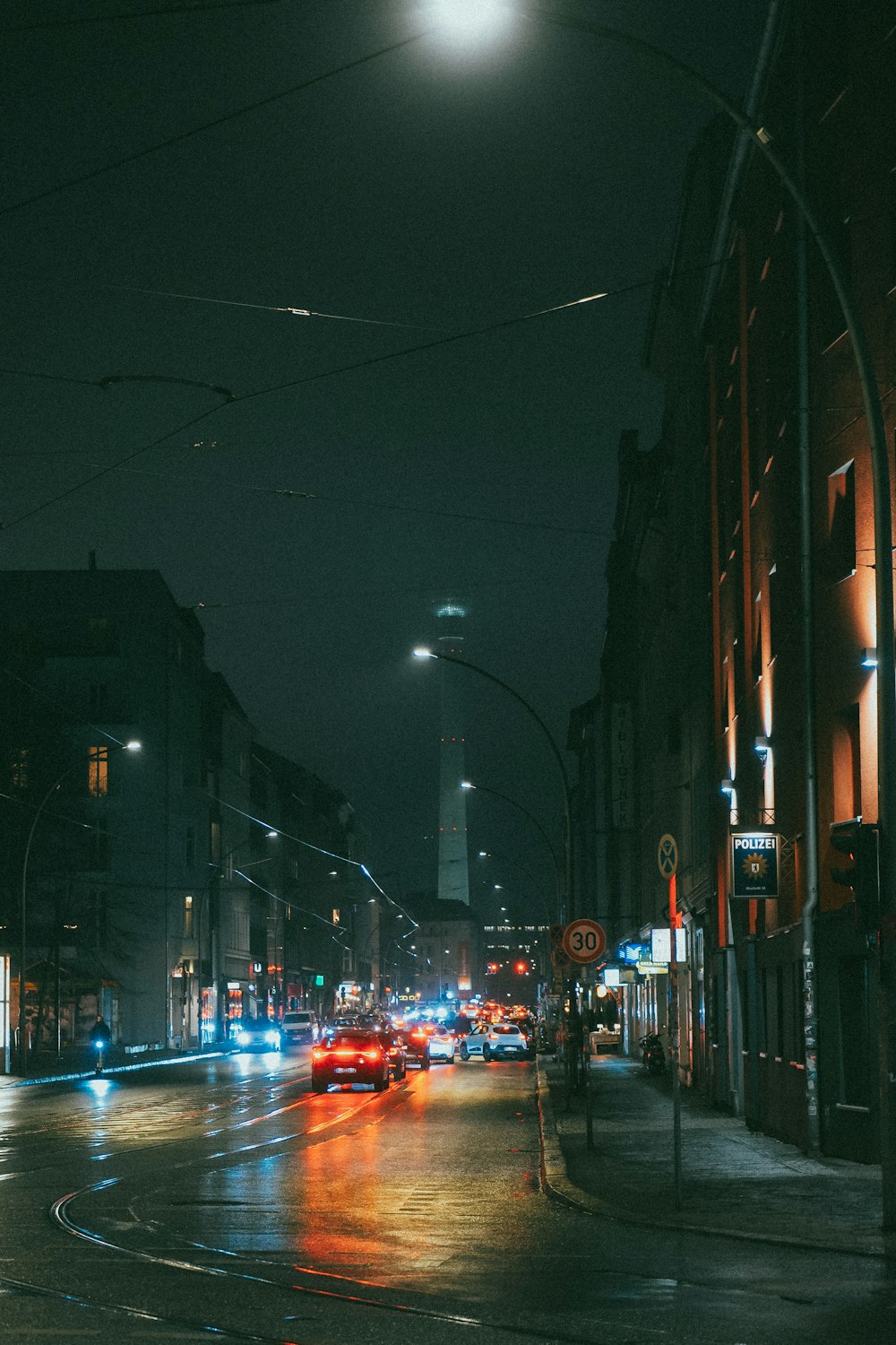 a city street filled with lots of traffic at night