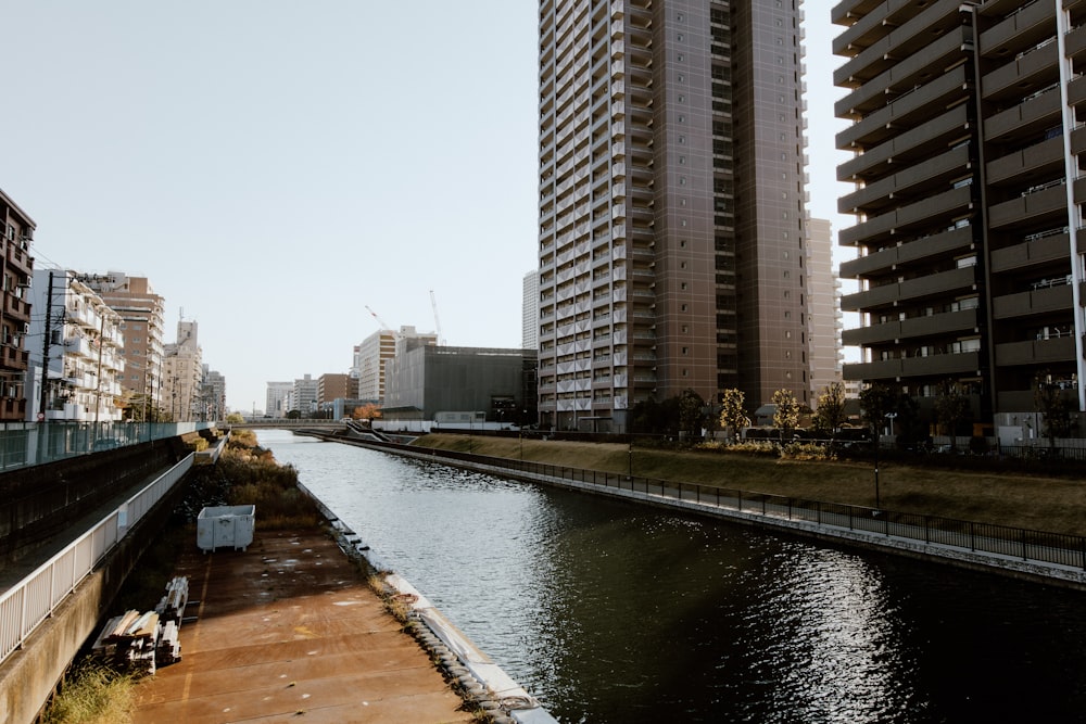 a river running through a city next to tall buildings