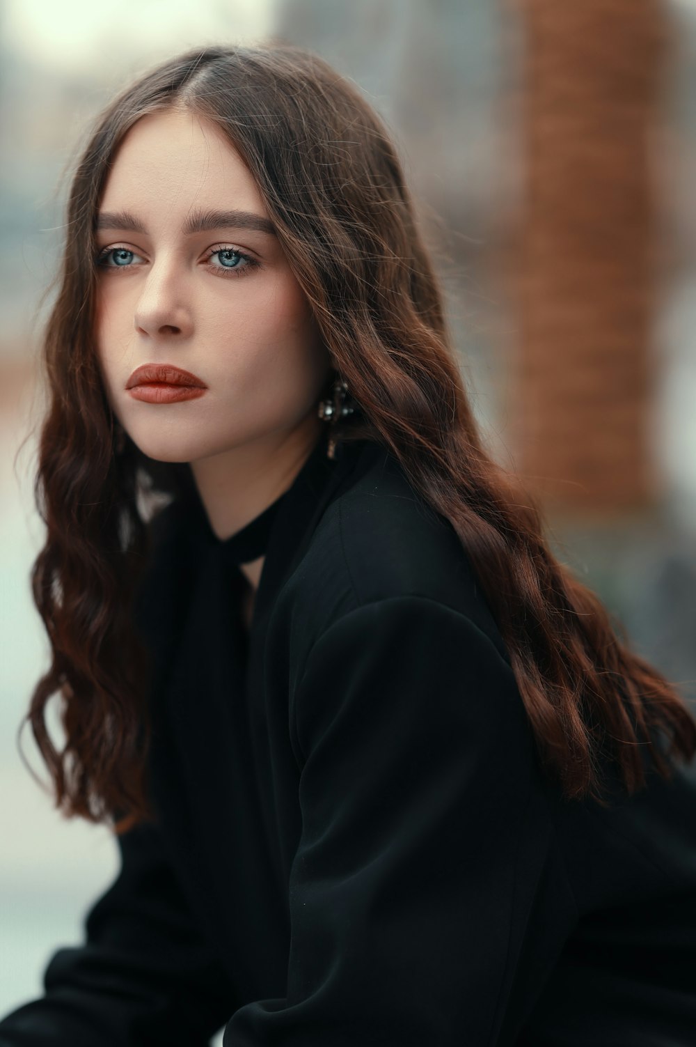 a woman with long brown hair and blue eyes