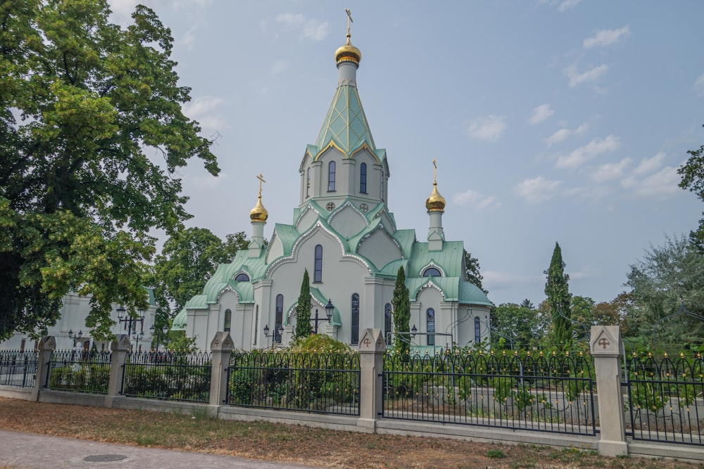 a large white church with a green roof