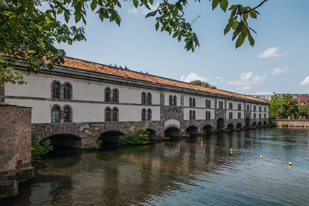 a bridge over a body of water next to a building