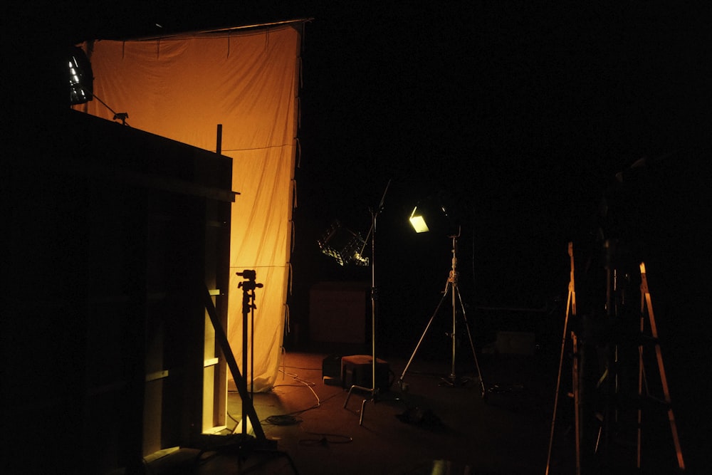 a dark room with lights and a curtain