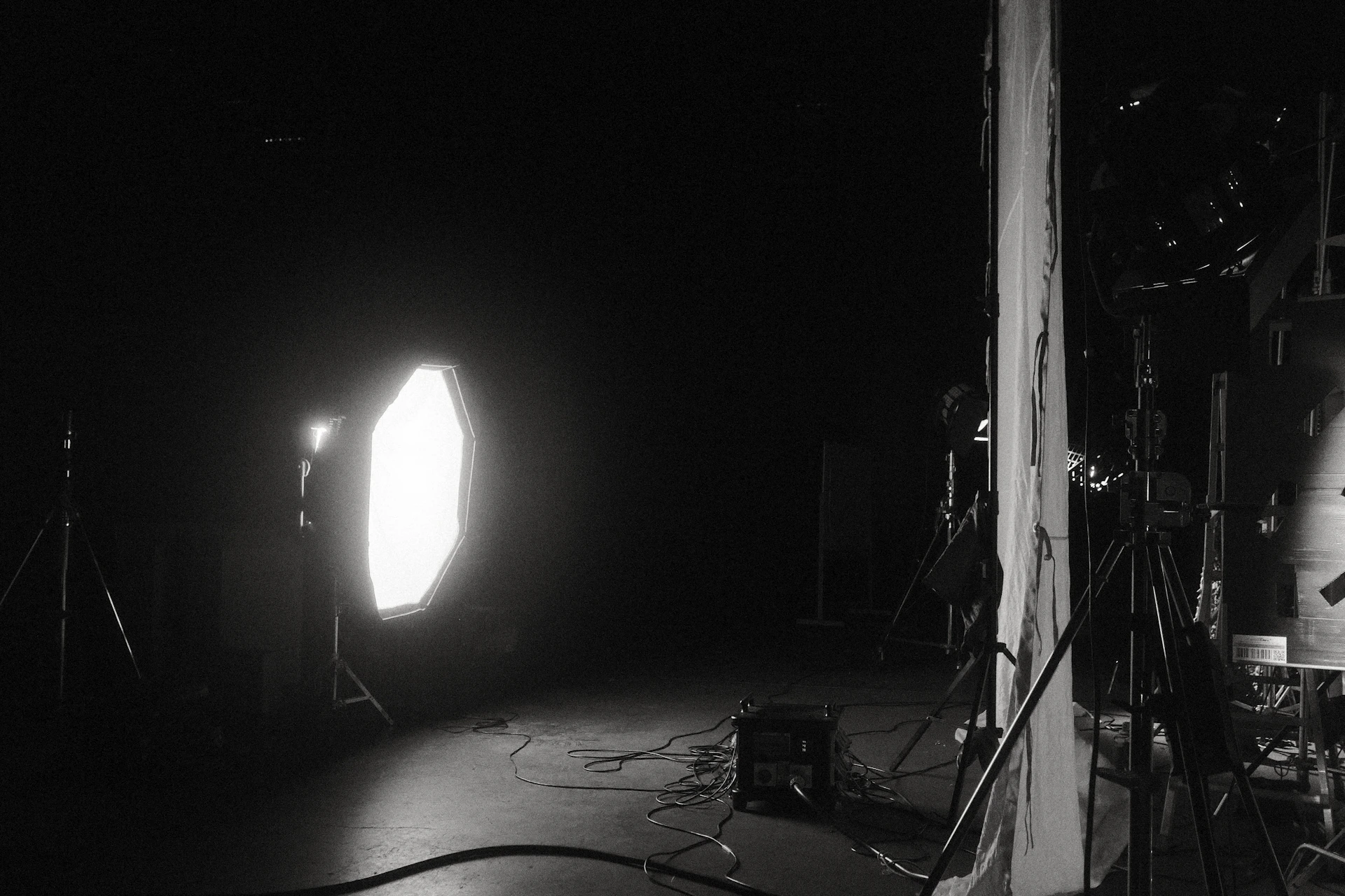 a black and white photo of a light in a dark room