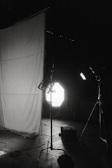 A well-lit studio with various photography equipment.