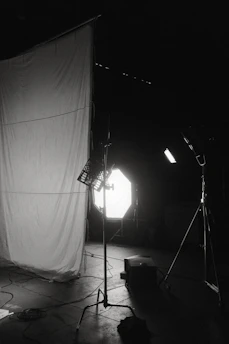 A warm-toned photo shoot setup with natural light and camera gear.