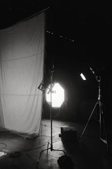 A minimalist elegant photo studio setup with soft natural lighting and camera equipment.