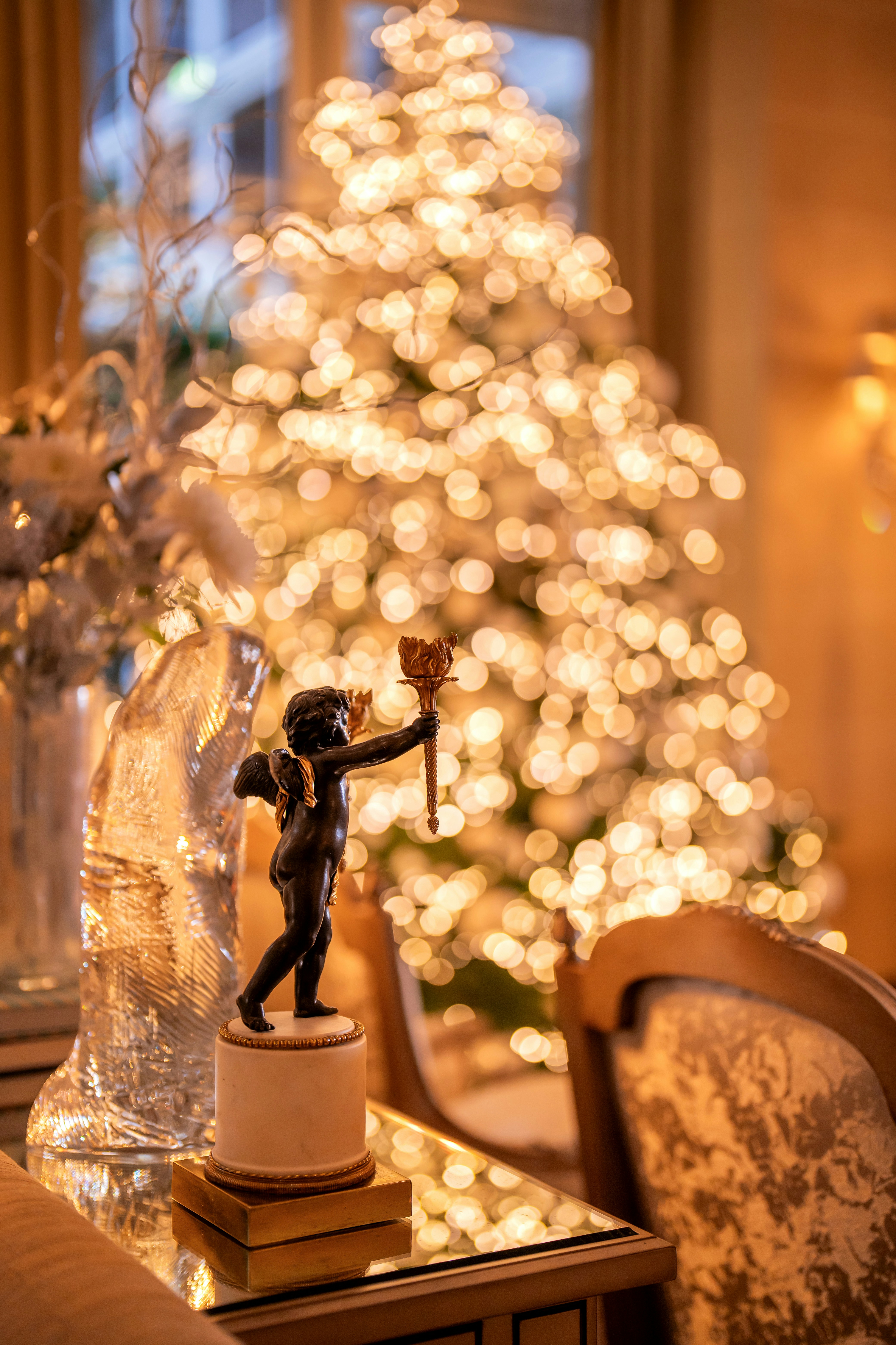 a statue of a person holding a torch on a table